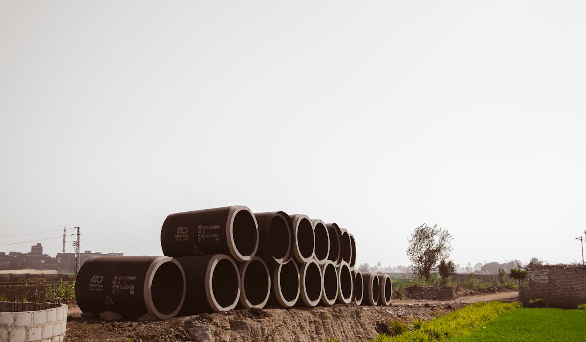 Large diameter concrete sewerage pipes stacked for an urban AMRUT 2.0 water and sewerage project